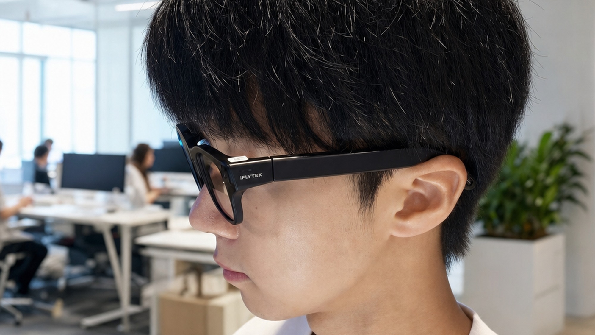 A professional wearing the lightweight 40 gram iFlytek AI glasses while reading a live translation in a bright modern office.