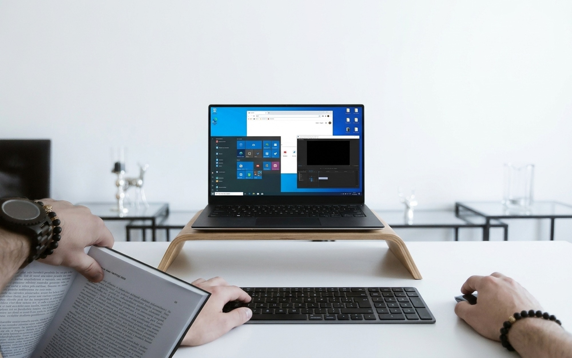 Young woman at a desk with two monitors one showing Netflix and one showing OBS recording software in a home office