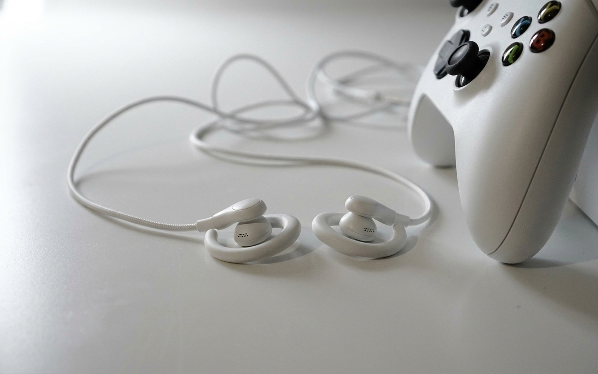 Close-up of Sony LinkBuds Clip open-ear earbuds resting on a white desk surface for design and build quality review