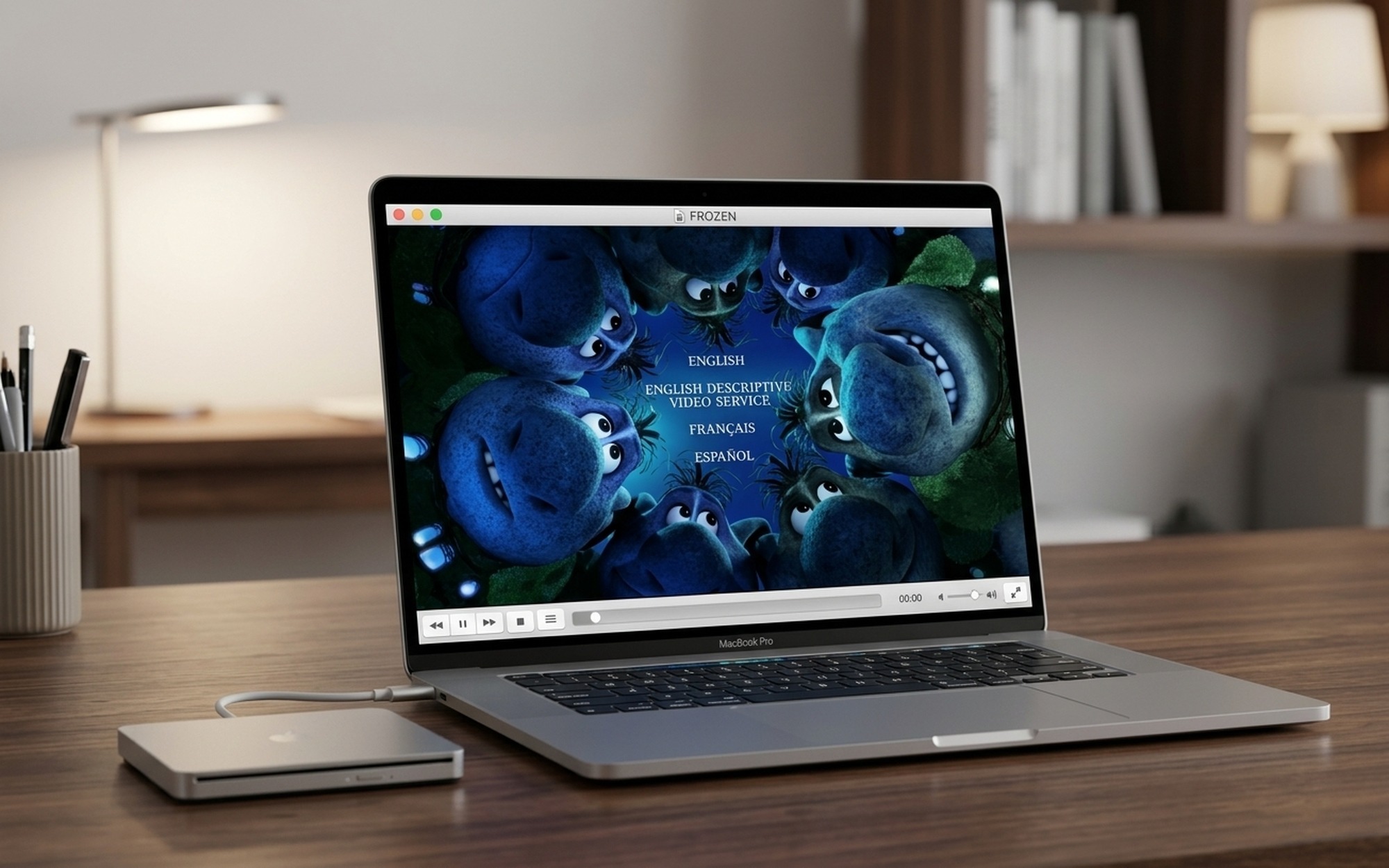 Person using external USB DVD drive with MacBook Pro to play a movie using VLC media player software