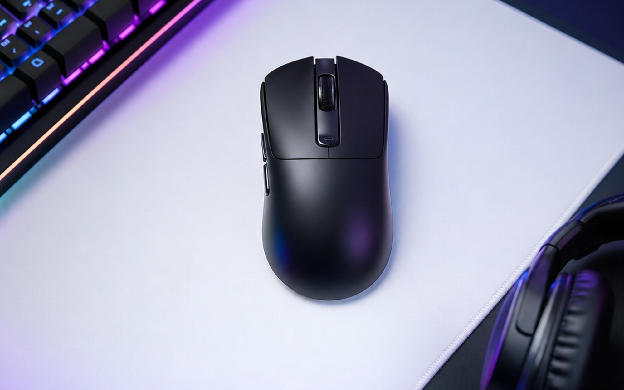 Xiaomi Gaming Mouse 2 lightweight wireless gaming mouse on mousepad beside RGB mechanical keyboard and headset