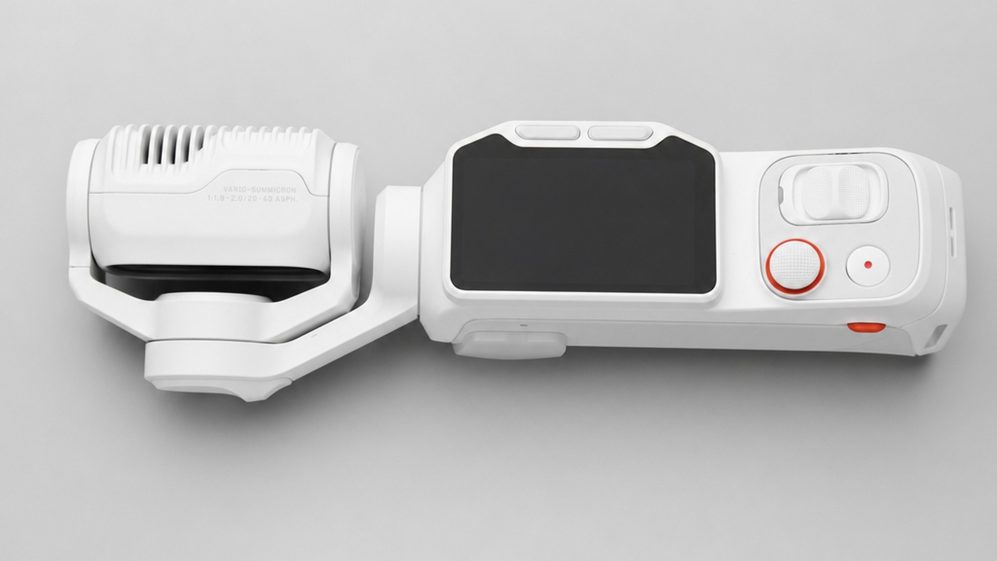 White Insta360 Luna Ultra with its gimbal head and detachable touchscreen monitor separated to show the modular camera design