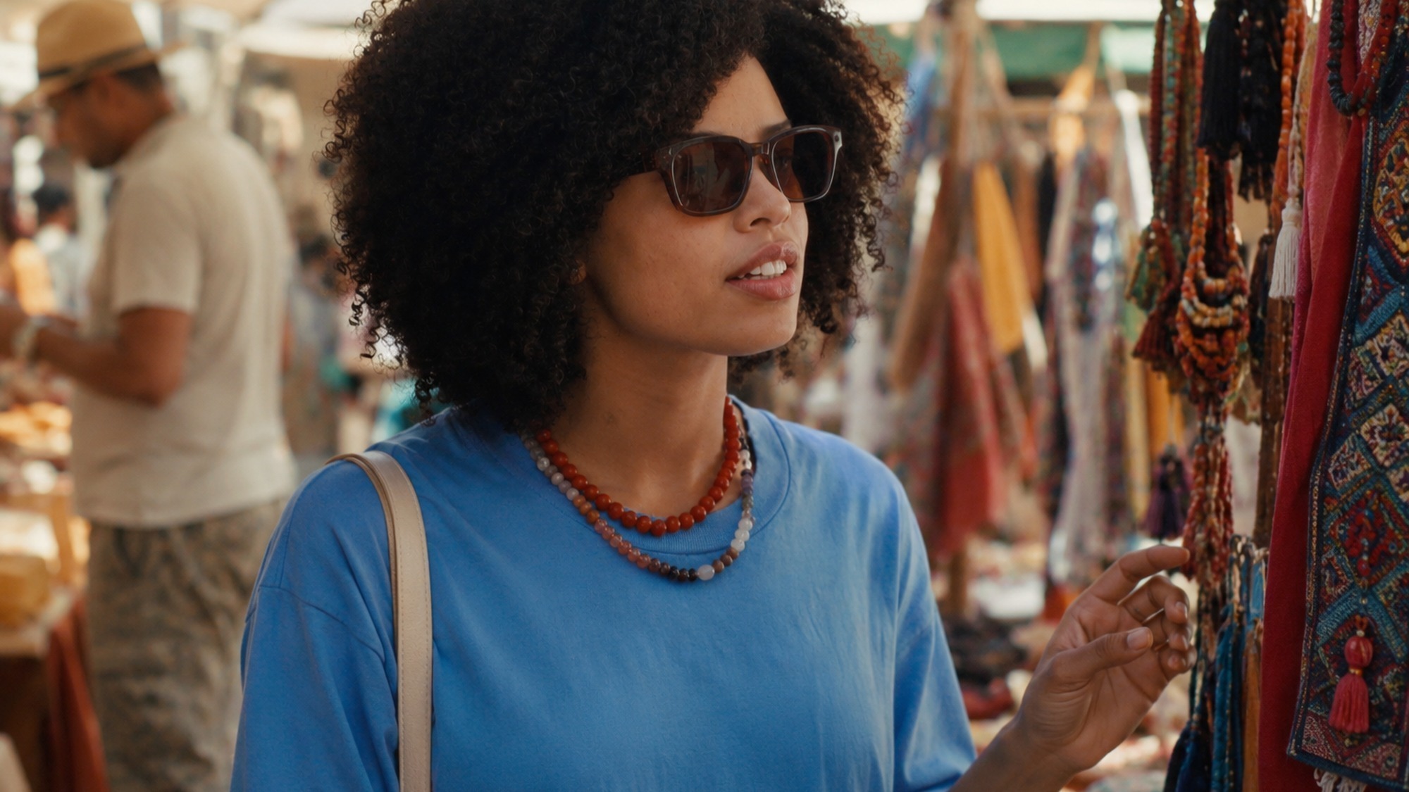 A woman wearing Meta AI glasses at a market stall asking the Hey Meta voice assistant a question hands free.