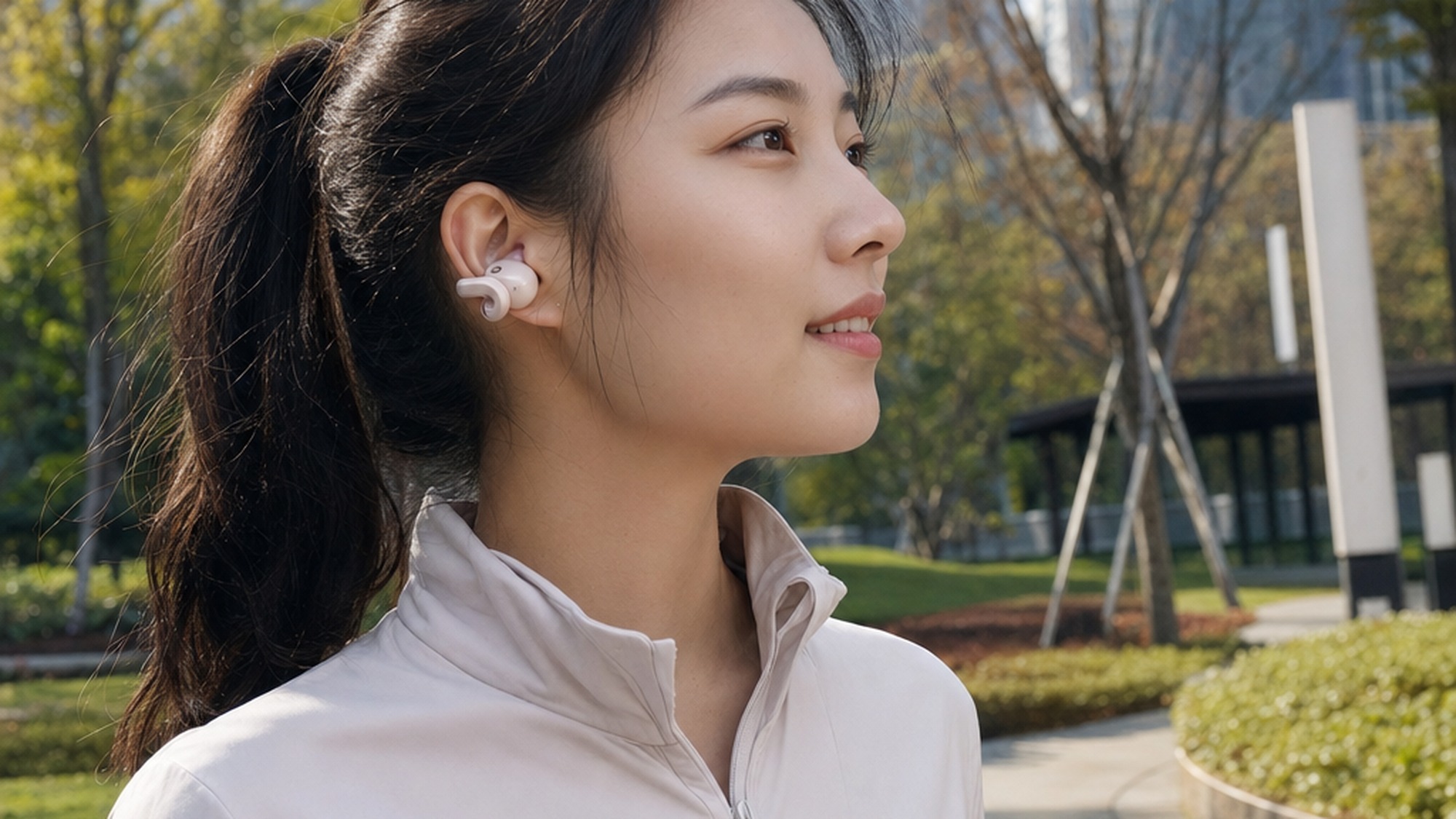 Shokz OpenDots 2 earbuds worn on ear in urban setting, showing how the flexible clip design wraps securely around the outer ear for hands-free listening